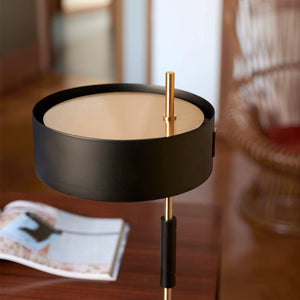 Oluce 1953 Floor Lamp – elegant black base and slim gold stem design