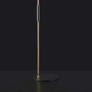 Oluce 1953 Floor Lamp – black and gold standing light against dark backdrop