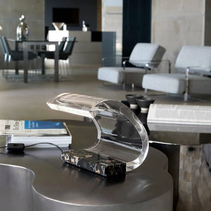 Oluce Acrilica 281/LBT table lamp on modern table with books by LoríaDesign