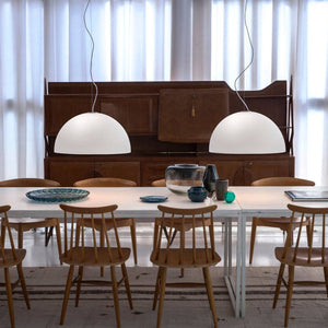 Oluce Sonora Pendant Lamps illuminating a modern dining space – Italian design lighting